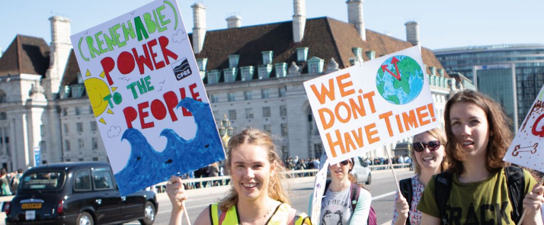 Climate protestors holding up banners