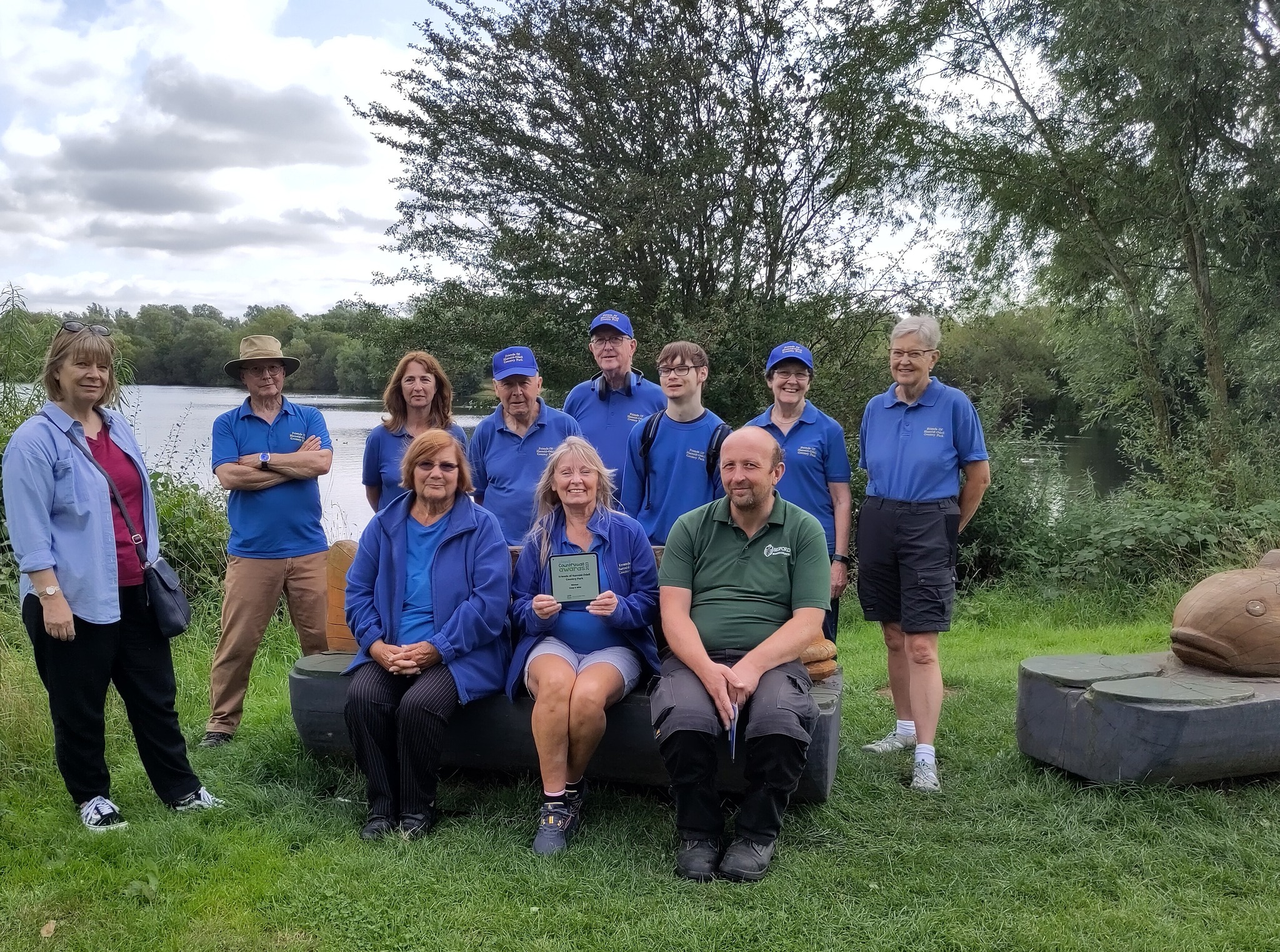 A group of volunteers, with a lake behind.