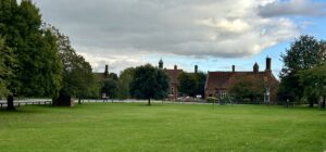 Buildings surrounding a large open green space.