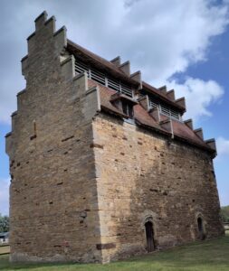 Close up of dovecote with steep gables and slatted entry holes.