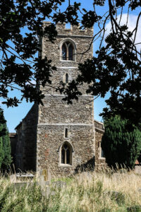 Church tower seen through trees.
