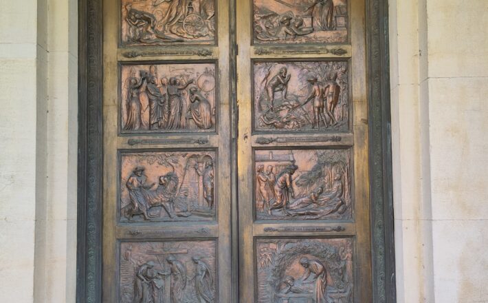 Bronze doors embossed with scenes from 'The Pilgrim's Progress'.