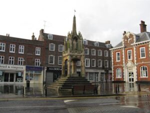 An octagonal market cross in a market square surrounded by Georgian buildings.