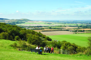 People sitting on Dunstable Downs looking at the view