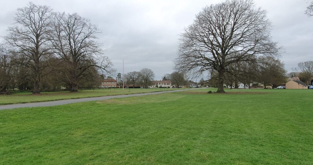 View of Ickwell village green with oak trees and maypole