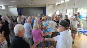 People at a public meeting in a village hall