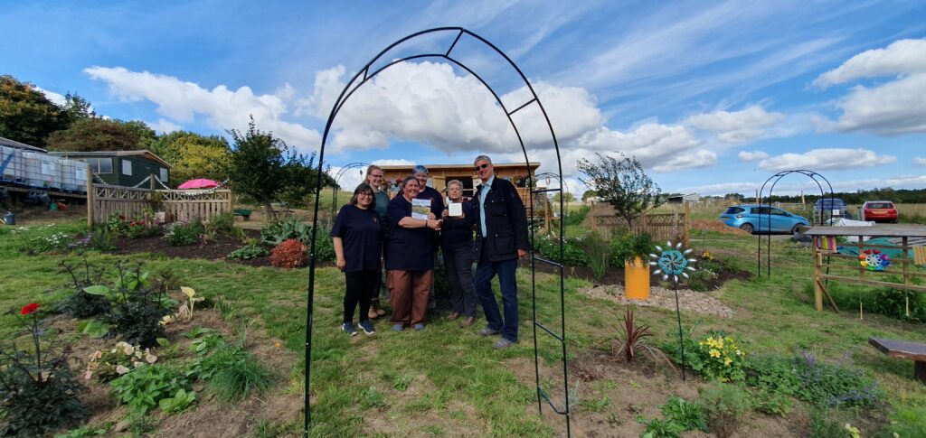 Volunteers receiving an award at a community garden