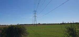 Electricity pylon across fields
