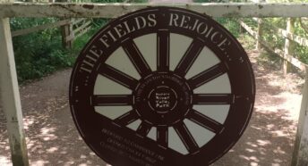 Gateway sign in the shape of a rail carriage wheel
