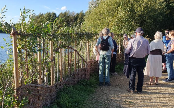 People looking at the new bird hide willow screen at Clophill Lakes